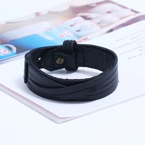 Close-up of black braided leather bracelet texture with secure metal snap button closure