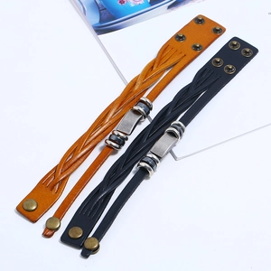 Detail showing high-quality black and brown braided leather bracelets with metal clasps