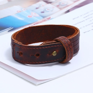 Close-up of vintage brown multilayer leather bracelet with brass rivet fasteners