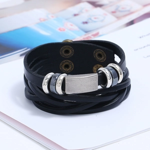 Close-up of multilayer black leather bracelet with silver metal plate and secure clasp