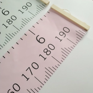Detail of canvas height chart featuring wooden rod and black scales up to 190cm