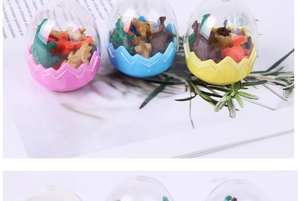 Close-up of colorful dinosaur egg erasers with miniature toy figures inside