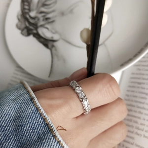 Minimalist 925 sterling silver band ring with pavé zircon stones on a model hand