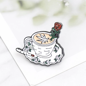 Punk enamel brooch featuring coffee cup with rose and cigarette on marble background