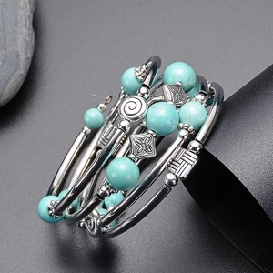 Multilayer wrap bracelet featuring natural turquoise beads and silver clover charms
