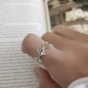 Vintage 925 sterling silver irregular star ring on model over open book pages
