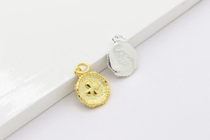 Macro detail of S925 sterling silver and 18K gold clover round pendant charms