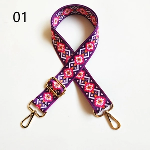Detail of bohemian purple guitar strap for handbags with gold hooks and folk patterns