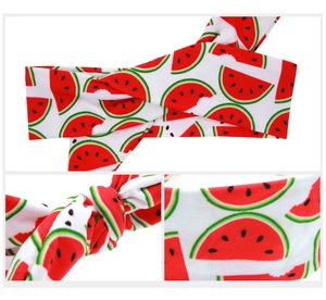 Detail view showing watermelon print and knot design on white elastic kids headband