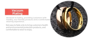 Close-up of polished vacuum-plated gold and rose gold rings on black texture background