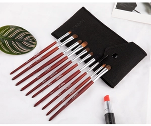 Detail of 12-piece professional makeup brush set with wooden handles and felt storage pouch