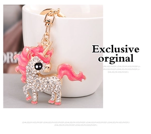 Macro detail of golden unicorn keychain with sparkling rhinestones and pink enamel finish