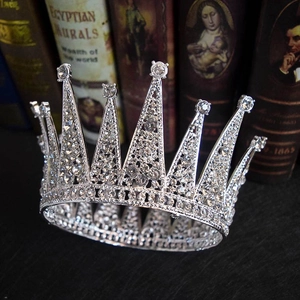 Macro shot of silver bridal crown with sparkling rhinestones on vintage book background