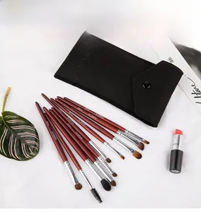 Close-up of 10-piece natural hair eye shadow brush set with wooden handles and felt pouch