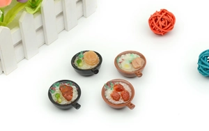 Macro shot of 4 realistic miniature PVC clay pot rice pendants with rich food details