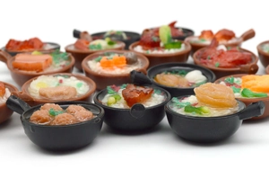 Detailed macro view of miniature PVC claypot rice models with realistic food textures