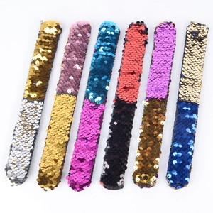 Detailed view of six colorful sequin slap bracelets for children Christmas party favors