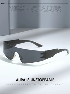 Macro detail of black shield sunglasses showing the seamless unrimmed lens and wide temples