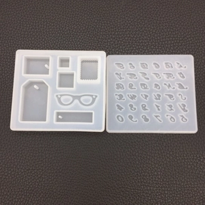 Detailed view of DIY silicone molds featuring alphabet, numbers, and geometric pendant shapes