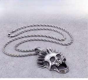 Macro shot of punk style stainless steel skull pendant with vintage silver oxidized finish