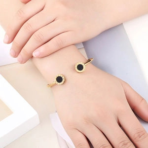 Classic rose gold stainless steel bangle with roman numerals and black onyx shell inlay