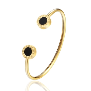 Macro detail of rose gold stainless steel bracelet with Roman numerals and black inlay