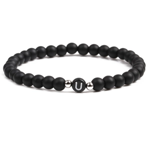 Detail shot of black matte stone bracelet with letter U bead and silver accents