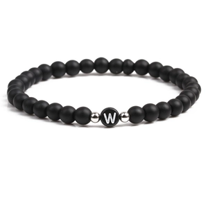 Detail of 6mm matte black stone beads with silver spacers and letter W heart bead