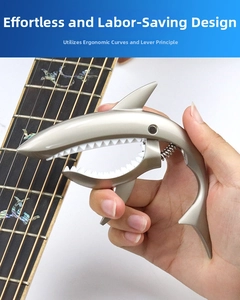 Macro view of zinc alloy shark guitar capo with soft protective padding and spring