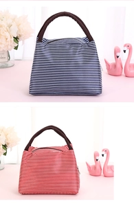 Detail of striped lunch bags with reinforced brown handles and secure zipper closure
