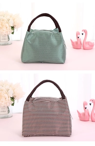 Detail of green and brown striped insulated lunch bags with durable woven handles
