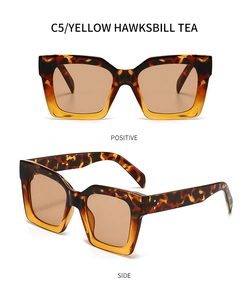 Detail view of square sunglasses in yellow hawksbill tea with triple stud accents