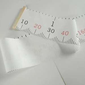 Detail of canvas height chart scale showing clear metric measurements with wooden frame ends