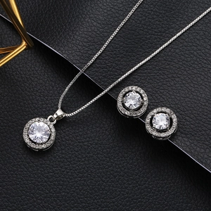 Elegant silver necklace and round cubic zirconia stud earrings jewelry set on black leather