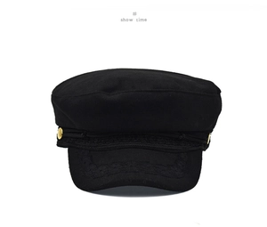 Detail of black wool newsboy cap featuring gold buttons and ornate embroidery