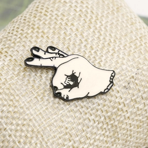 Punk style OK gesture hand enamel brooch with crack design on beige background