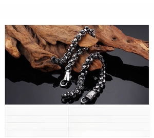 Close-up of punk style stainless steel skull bracelet on wood with specifications