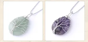 Detail of tree of life wire-wrapped crystal teardrop necklaces in green and purple