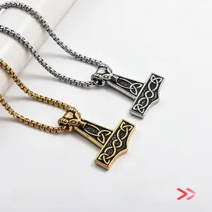 Detail of Thor's hammer pendants with ram head design and Celtic knots in gold and silver