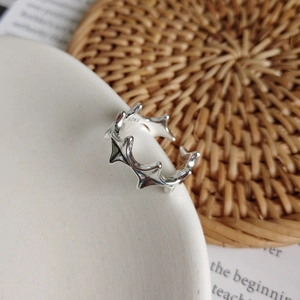 Detail of S925 sterling silver liquid metal ring with engraved hallmark on a ceramic plate