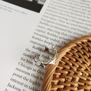 Detail of S925 sterling silver irregular star ring on vintage book background
