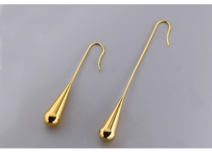 Detailed view of polished golden water drop earrings with elegant long hook design