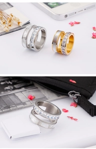 Detail of stacked shell rings in silver and gold with square zircon inlay on steel