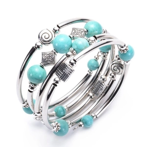Multilayer wrap bracelet featuring natural turquoise beads and engraved silver metal coils