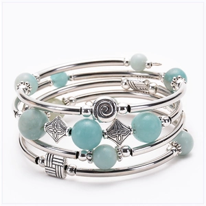 Close-up of multilayer turquoise wrap bracelet with silver textured metal tubes