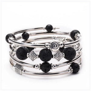 Macro shot of multi-layer bracelet with black lava stone beads and retro silver spacers