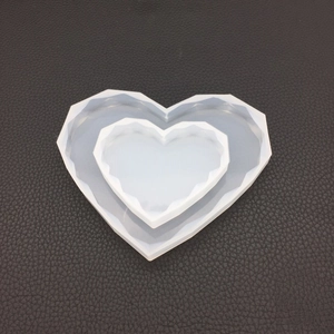 Detail of heart-shaped silicone resin mold set with geometric facets for DIY crafts