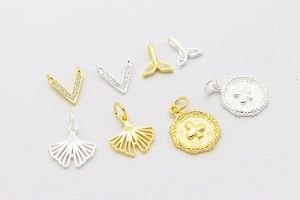 Detailed collection of 925 silver fishtail and ginkgo leaf pendants with gold plating
