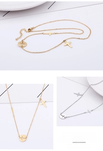 Macro detail of gold and silver stainless steel cross necklaces on a white tray