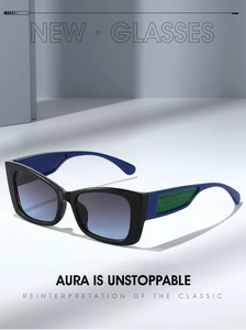 Detail of cat-eye sunglasses with green crackle texture on blue temples and gradient lenses